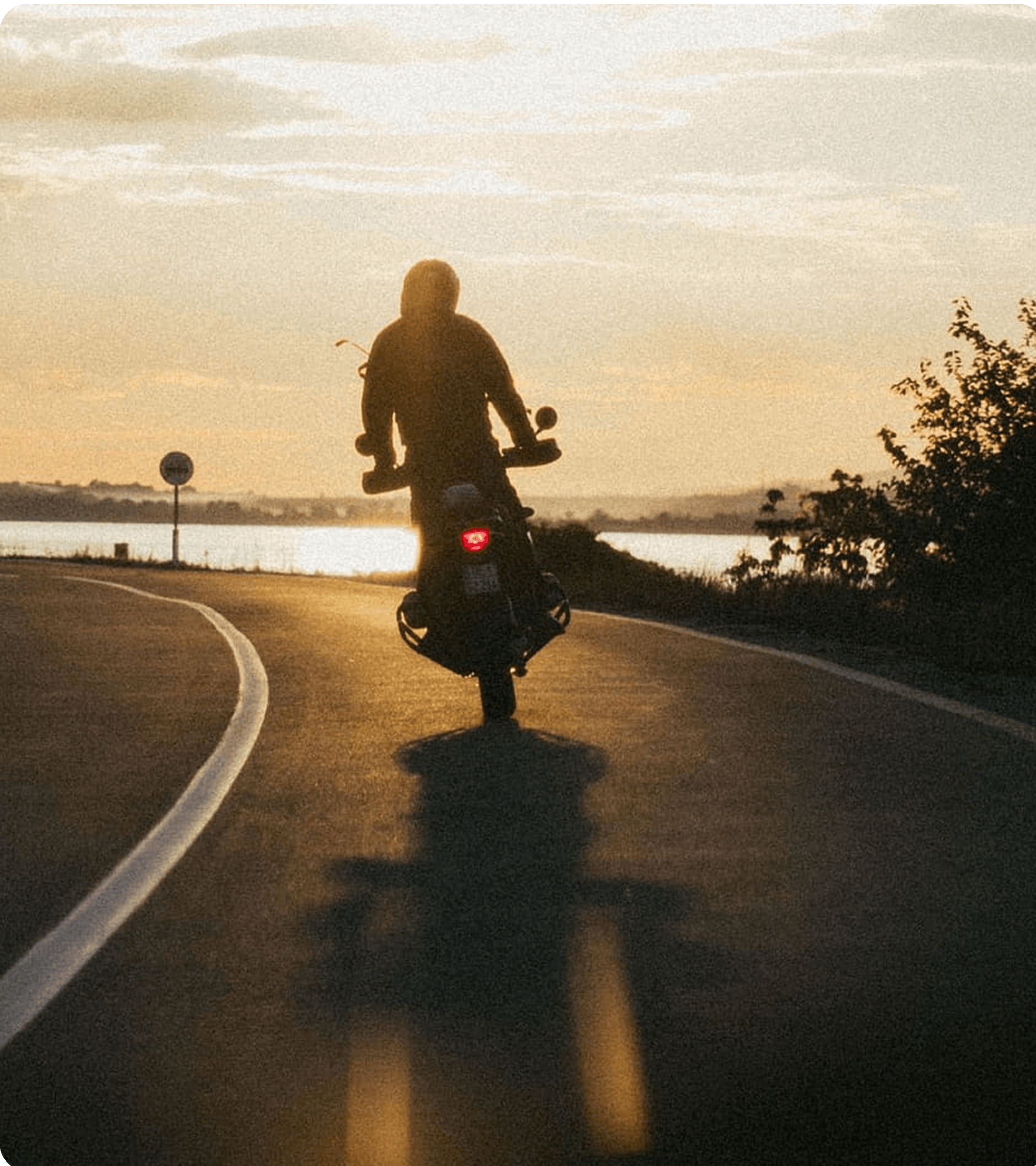 Motorcyclist riding during sunset