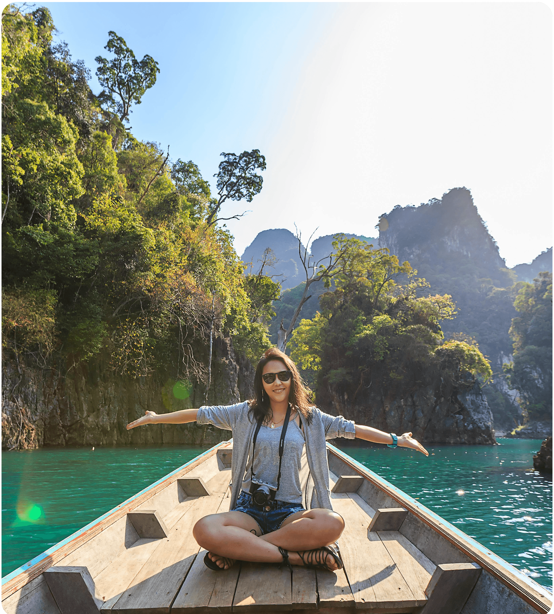Woman in a boat exploring mountains and water